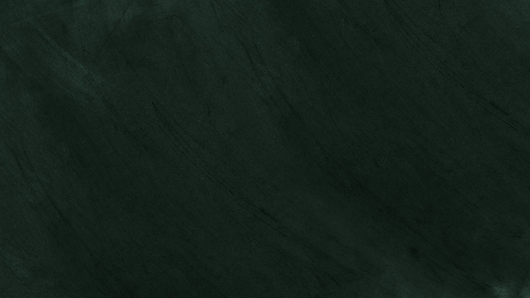 Dark green chalkboard surface with faint diagonal scuff marks and no text