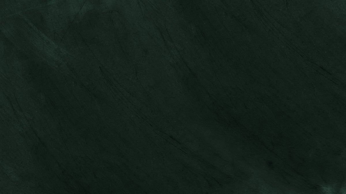 Dark green chalkboard surface with faint diagonal scuff marks and no text