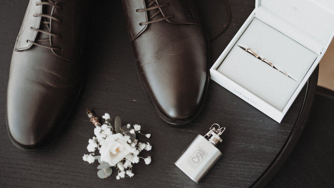 which hand do men wear wedding ring — groom flat lay with plain wedding bands — FoundryCut