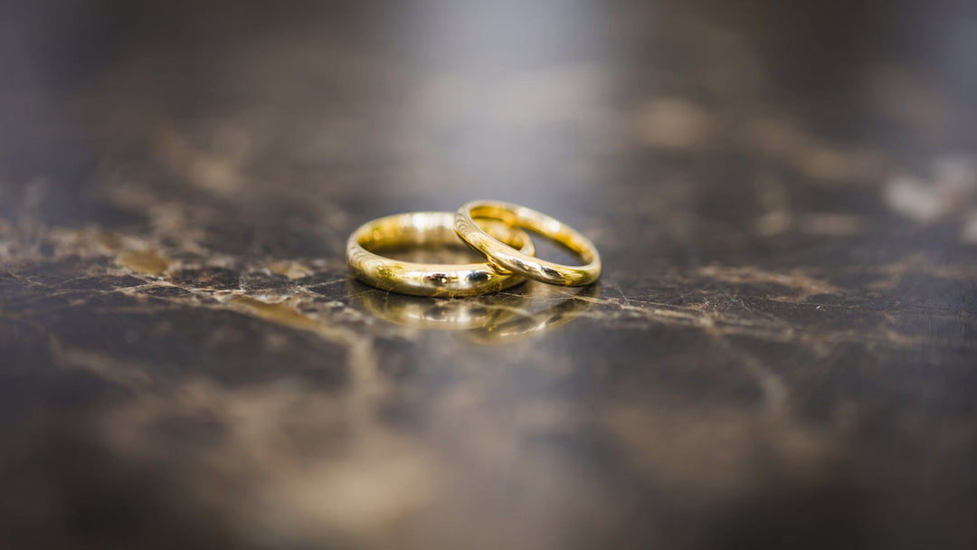 rose gold wedding bands for men on dark marble surface — FoundryCut