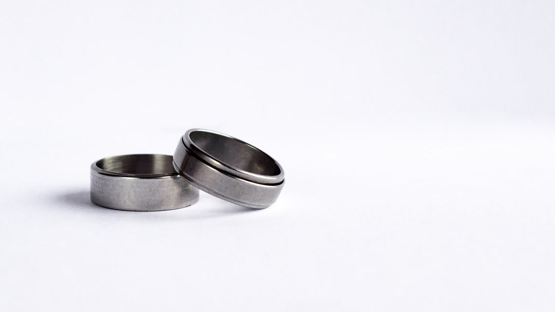 tungsten carbide vs tungsten — two wide brushed silver tungsten bands on white background — FoundryCut