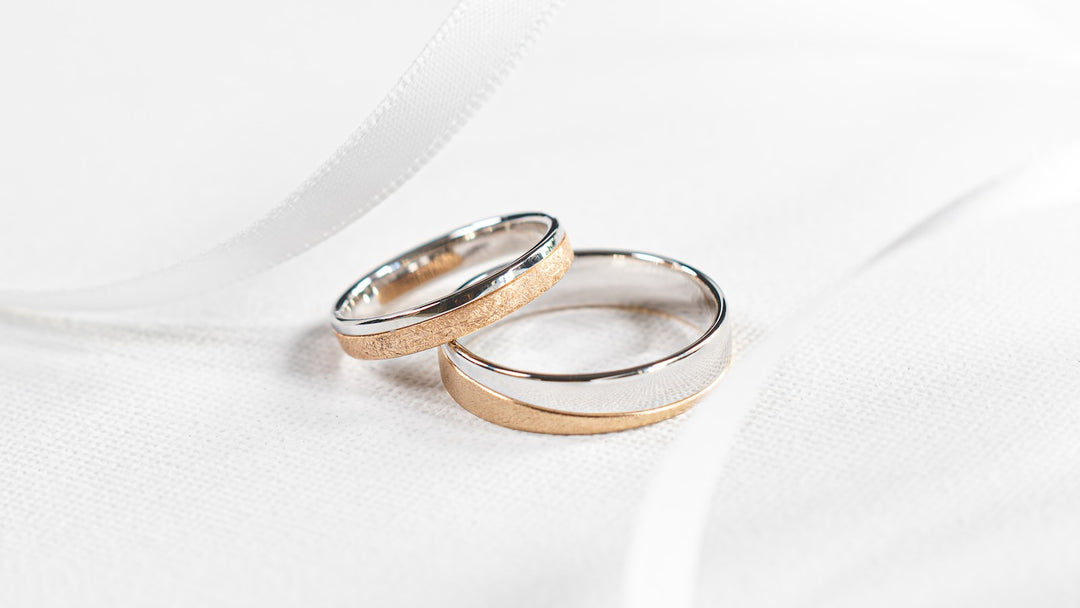 two tone wedding band for men flat-lay — silver and rose gold